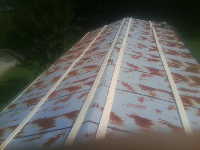 Rusted metal roof panels with new wood purlins before replacement — Storm Damage Roof Repair in Stinson Beach by Roofing Brothers