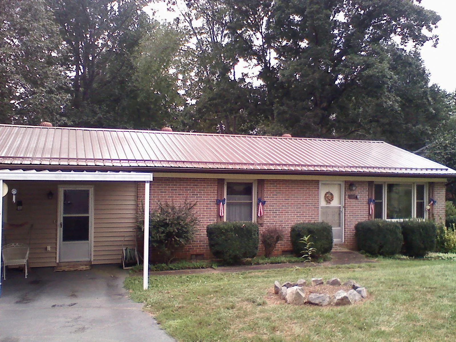 Bronze metal roof and carport on a brick ranch home — Roof Repair work by our crew in Stinson Beach