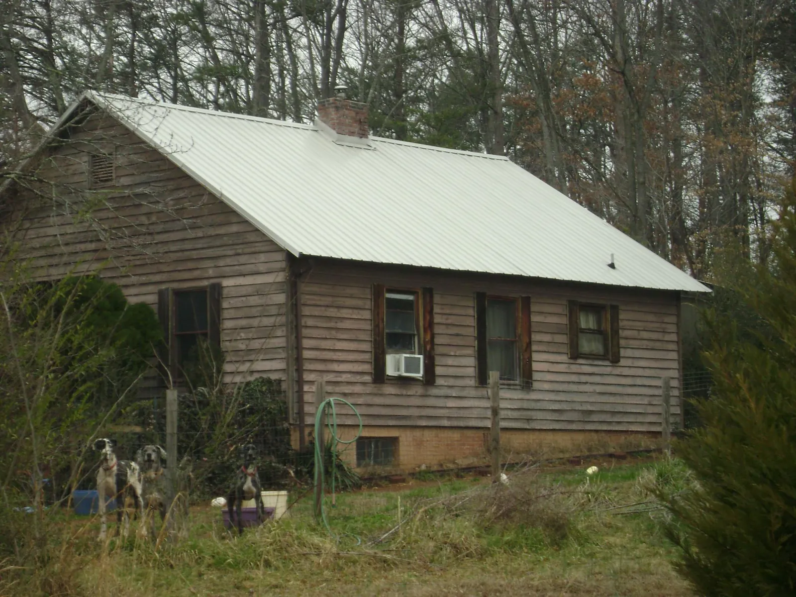 White metal roof on an old wood sided farmhouse, from a Metal Roof Installation job in Stinson Beach